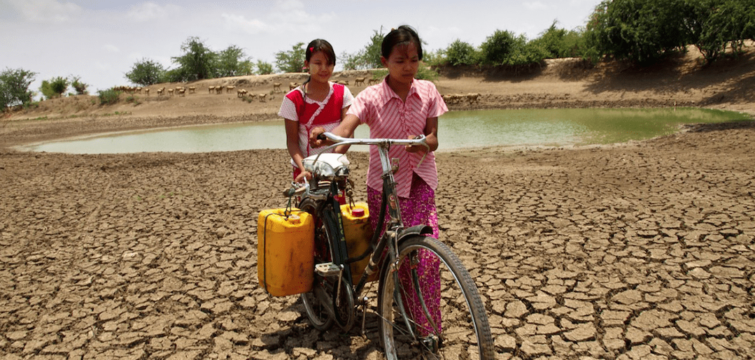 Women carrying water in Myanmar