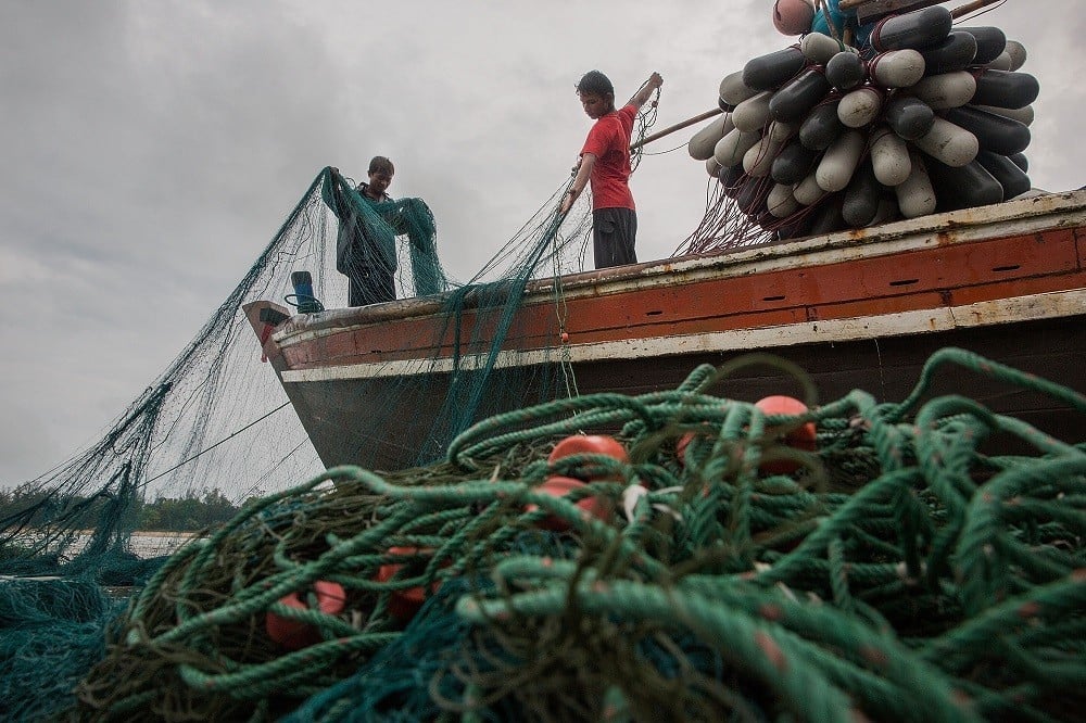 BAWAR, BURMA - AUGUST 02: Burmese fishermen prepare their nets before a voyage near the planned Dawei SEZ on August 2, 2015 in Bawar Village, Burma. The controversial, multi-billion dollar Dawei special economic zone and deep sea port has been stuck in a quagmire for years, however, three-way meetings between Thailand, Myanmar, and Japan have pushed the project closer with an agreement to develop the first stage of construction expected this week. The plan is expected to displace thousands of local residents from at least five villages and local farmers and fishermen are worried that the massive project will negatively effect their livelihoods. (Photo by Taylor Weidman/Getty Images)