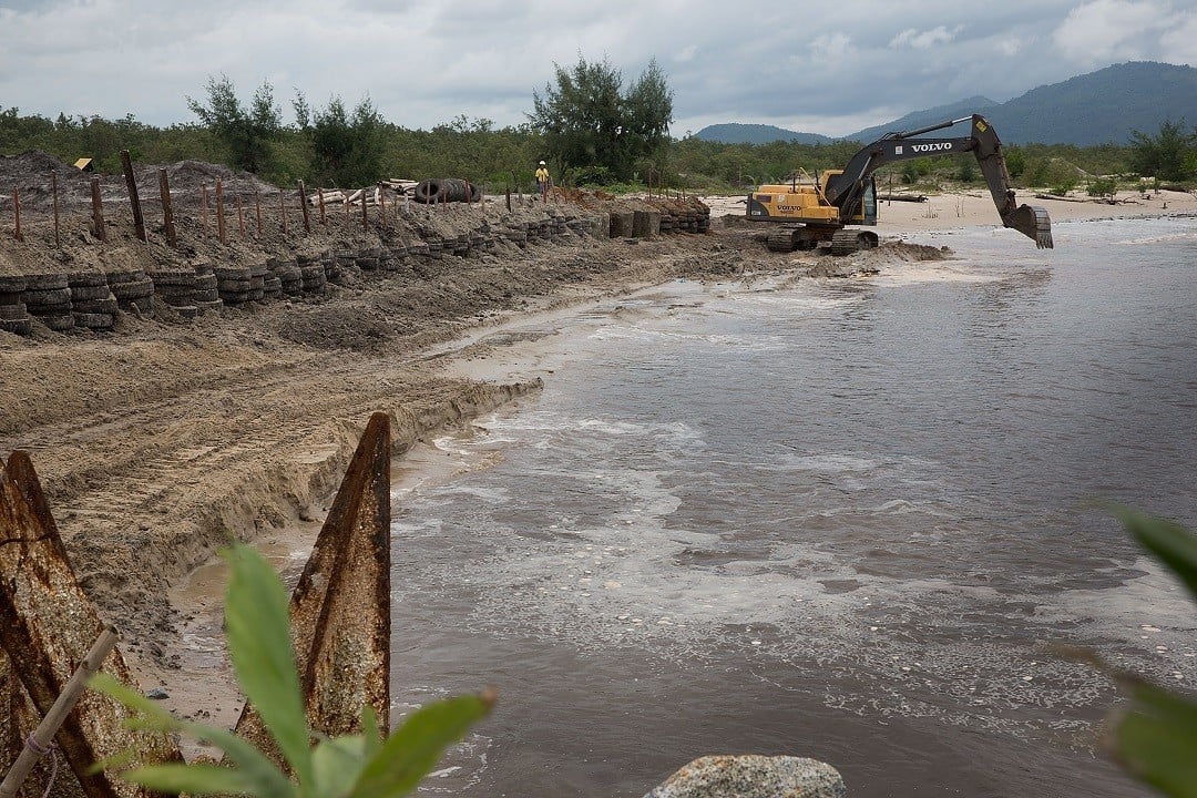 NGAPITAT, BURMA - AUGUST 03: Construction workers build a small, interim port inside the planned Dawei SEZ on August 3, 2015 in Ngapitat, Burma. The controversial, multi-billion dollar Dawei special economic zone and deep sea port has been stuck in a quagmire for years, however, three-way meetings between Thailand, Myanmar, and Japan have pushed the project closer with an agreement to develop the first stage of construction expected this week. The plan is expected to displace thousands of local residents from at least five villages and local farmers and fishermen are worried that the massive project will negatively effect their livelihoods. (Photo by Taylor Weidman/Getty Images)