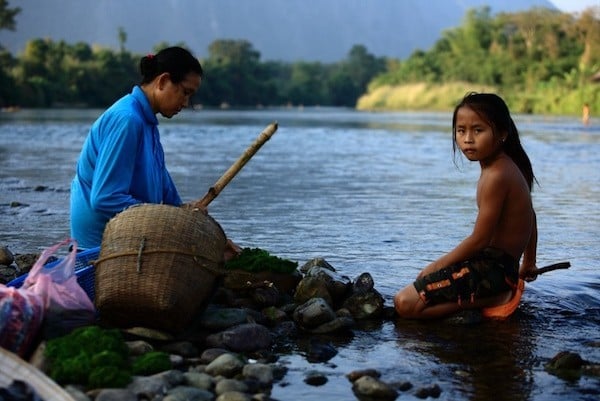 A Khmer woman selects her catches of the day with her from her daughter 